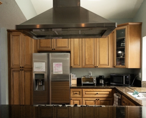Fully equipped kitchen with updated appliances and organized shared spaces.