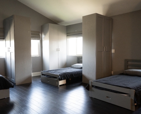 Clean and spacious shared bedroom designed to provide comfort, stability, and a respectful living environment.